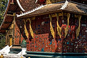 Wat Xieng Thong temple in Luang Prabang, Laos.  La Chapelle Rouge , the Red Chapel. Details of the consoles of the roof. 